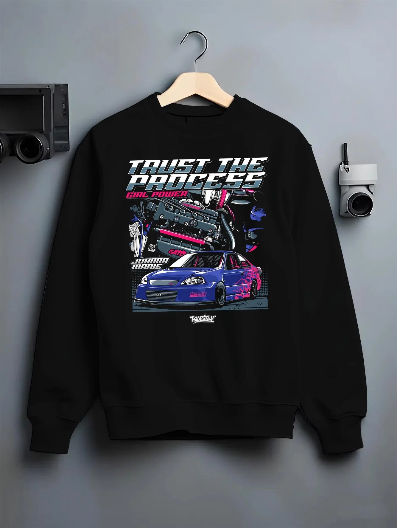 Black crewneck sweatshirt on a hanger against a grey wall, featuring Honda Civic racing jdm tuner street power performance graphic.