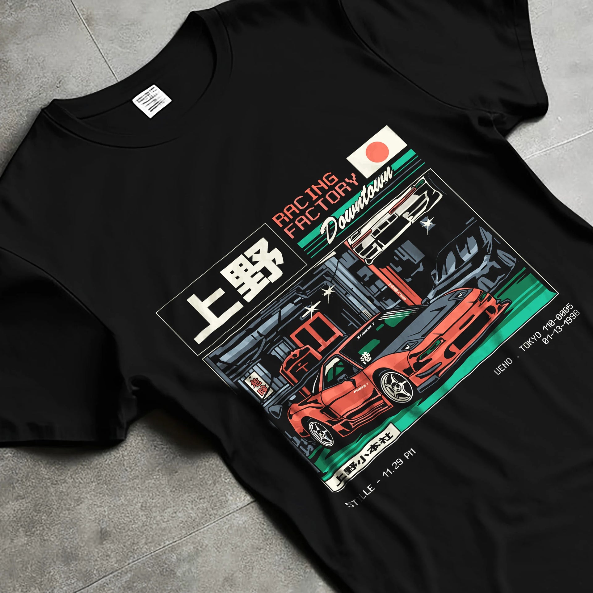 Black T-shirt laid flat with natural fabric folds, featuring Honda rs racing motorsport street retro classic speed graphic.