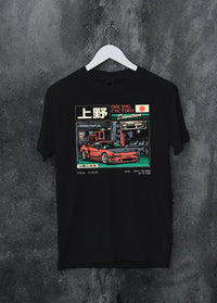 Black crewneck T-shirt on a hanger against a grey wall, featuring Honda rs racing motorsport street retro classic speed graphic.