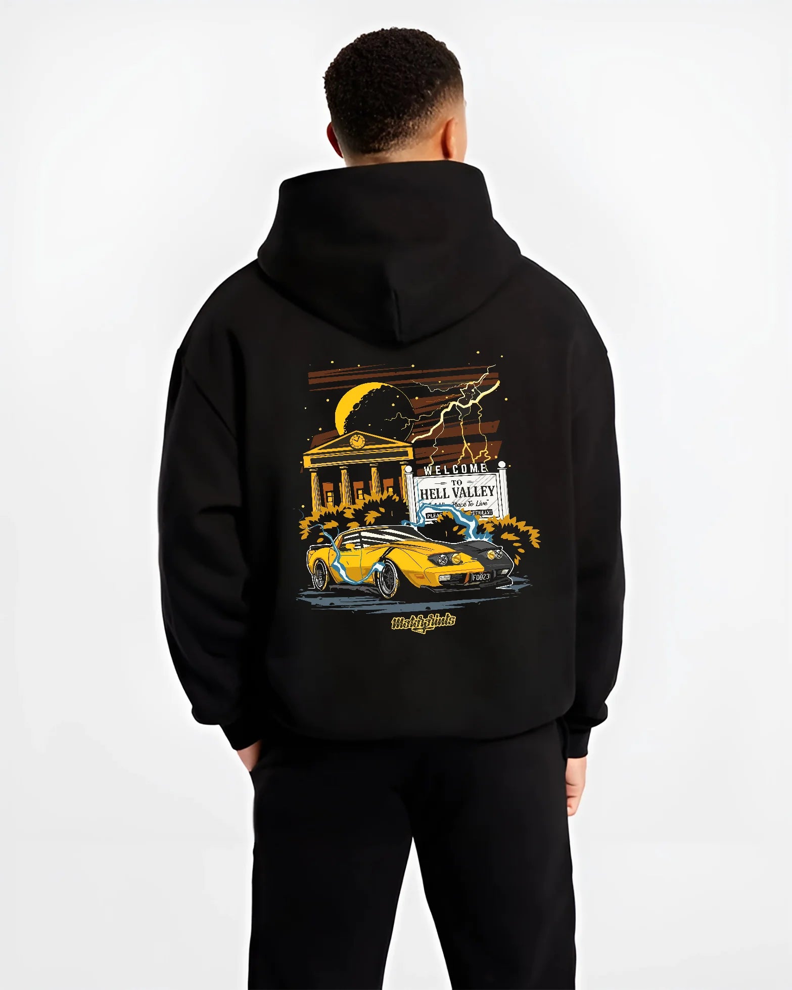 Black hoodie worn by a male model, back view, featuring racing street retro performance motorsport automotive enthusiast graphic.