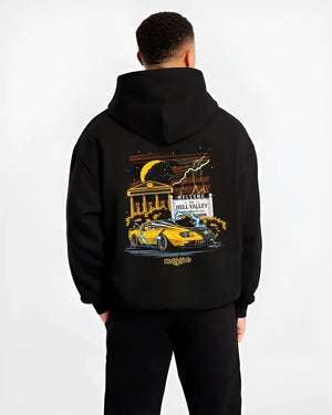 Black hoodie worn by a male model, back view, featuring racing street retro performance motorsport automotive enthusiast graphic.
