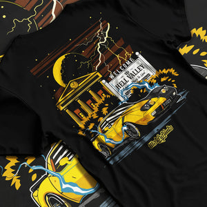 Black T-shirt laid flat with natural fabric folds, featuring racing street retro performance motorsport automotive graphic.