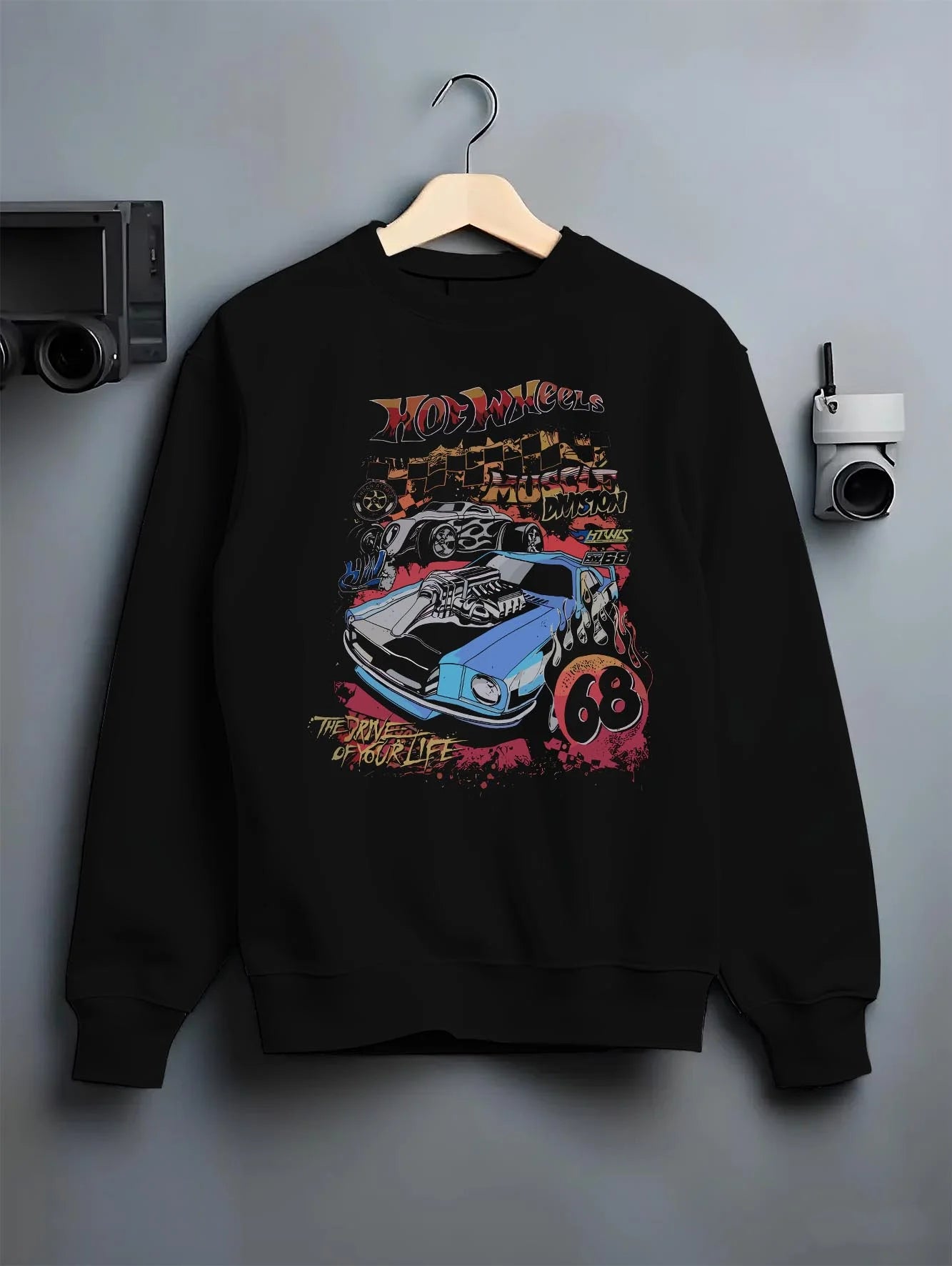 Black crewneck sweatshirt on a hanger against a grey wall, featuring ls racing drift muscle street retro legend performance graphic.