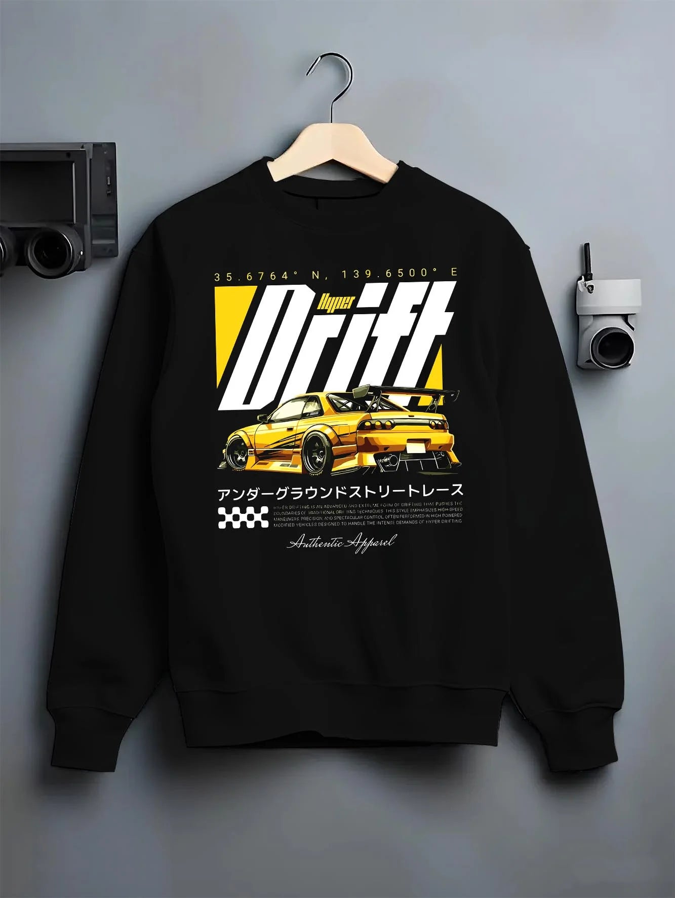 Black crewneck sweatshirt on a hanger against a grey wall, featuring racing drift jdm japanese tuner street legend graphic.