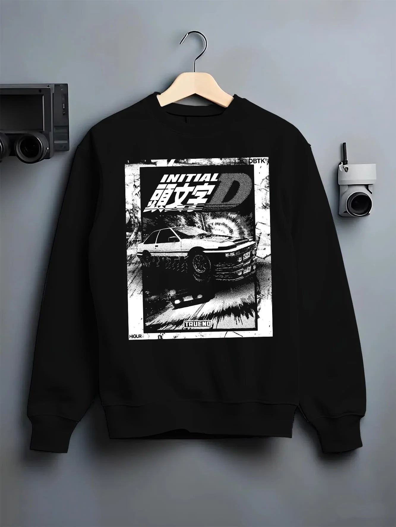 Black crewneck sweatshirt on a hanger against a grey wall, featuring racing drift jdm japanese initial d street legend graphic.