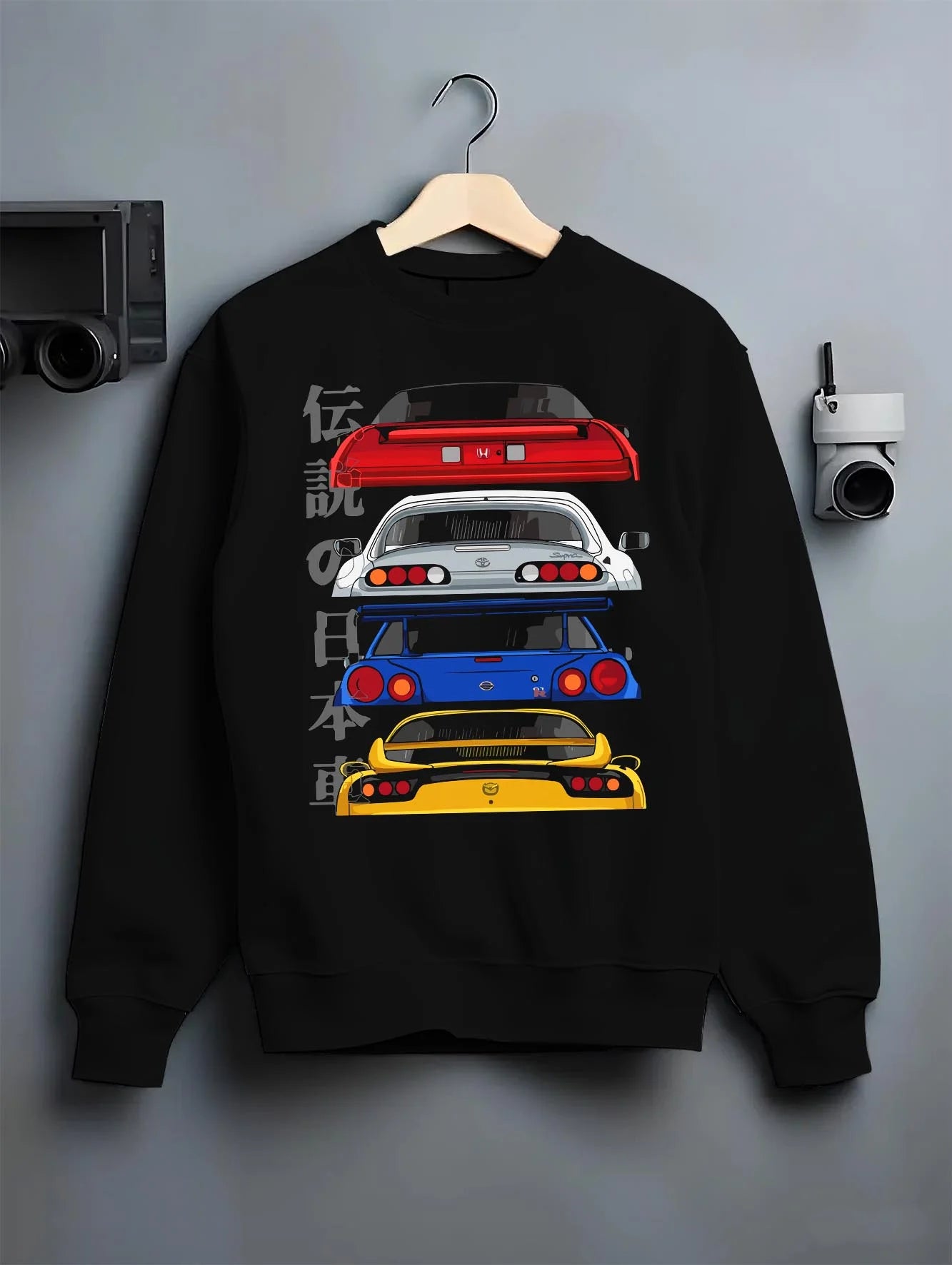 Black crewneck sweatshirt on a hanger against a grey wall, featuring drift jdm japanese tuner legend racing street graphic.