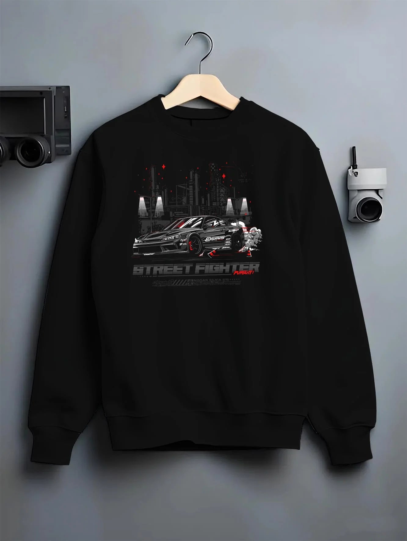 Black crewneck sweatshirt on a hanger against a grey wall, featuring rs racing drift jdm tuner street enthusiast graphic.