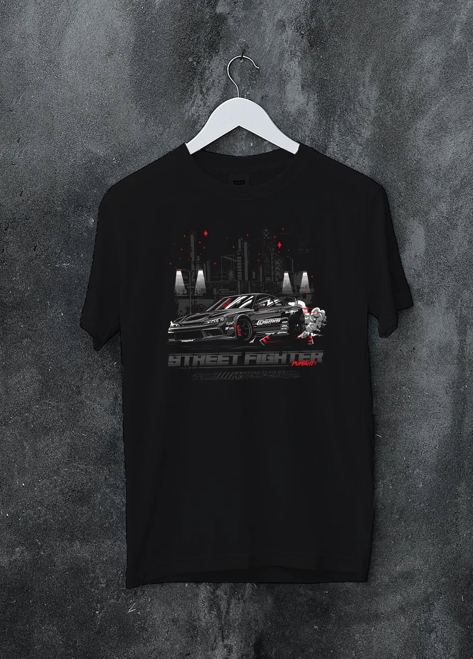Black crewneck T-shirt on a hanger against a grey wall, featuring rs racing drift jdm tuner street enthusiast performance graphic.