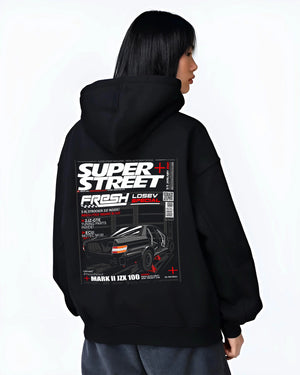 Black hoodie worn by a female model, back view, featuring Toyota JZX100 turbo drift street racing performance motorsport graphic.