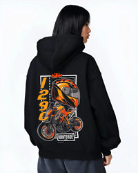 Black hoodie worn by a female model, back view, featuring KTM racing street performance motorsport automotive enthusiast graphic.