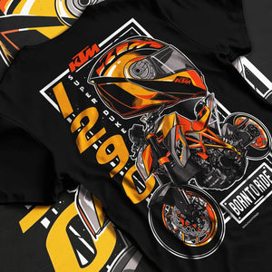 Black T-shirt laid flat with natural fabric folds, featuring KTM racing street performance motorsport automotive enthusiast graphic.