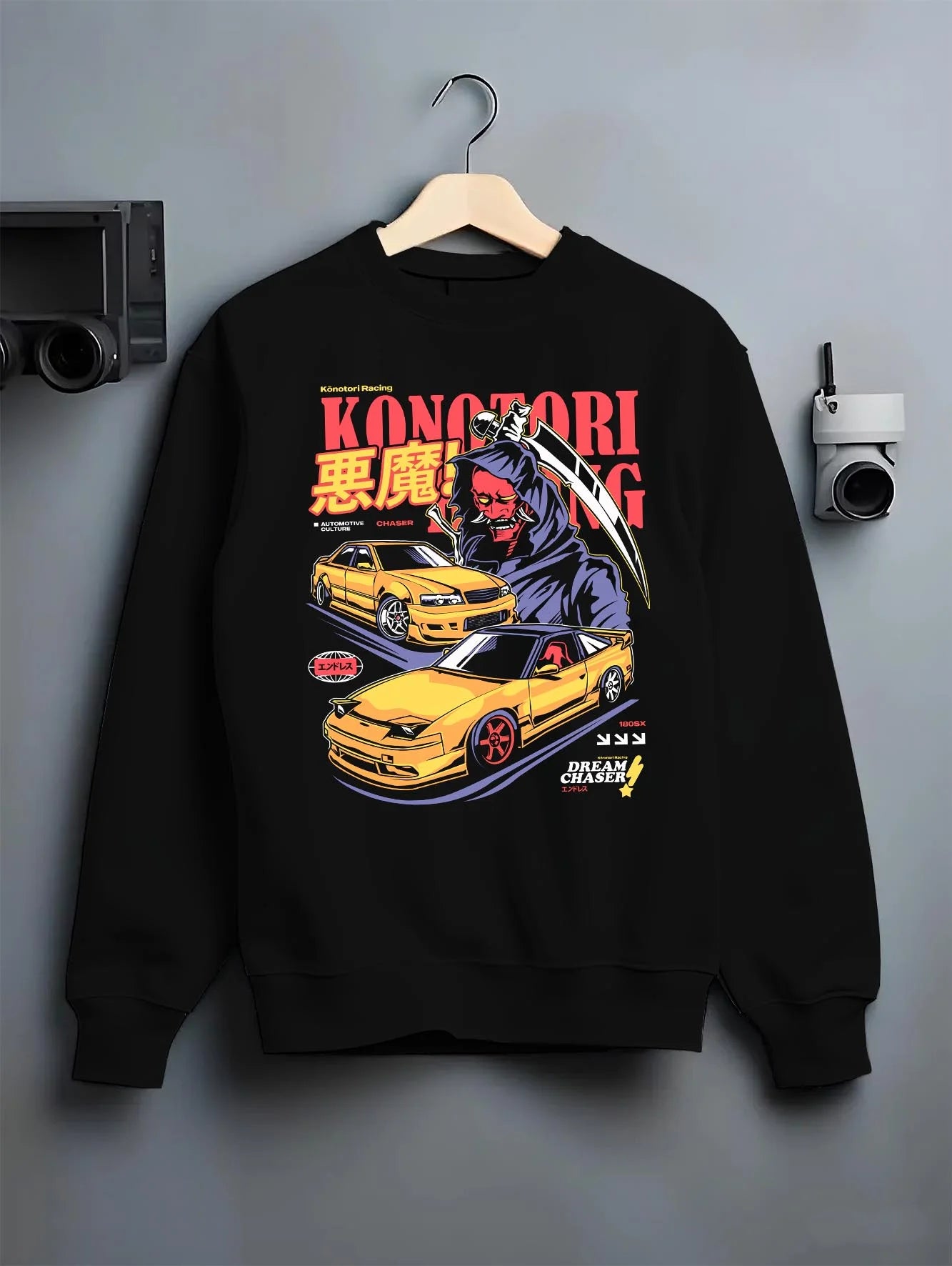 Black crewneck sweatshirt on a hanger against a grey wall, featuring rs racing drift jdm japanese street performance graphic.