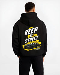 Black hoodie worn by a male model, back view, featuring turbo racing drift tuner street performance motorsport automotive graphic.