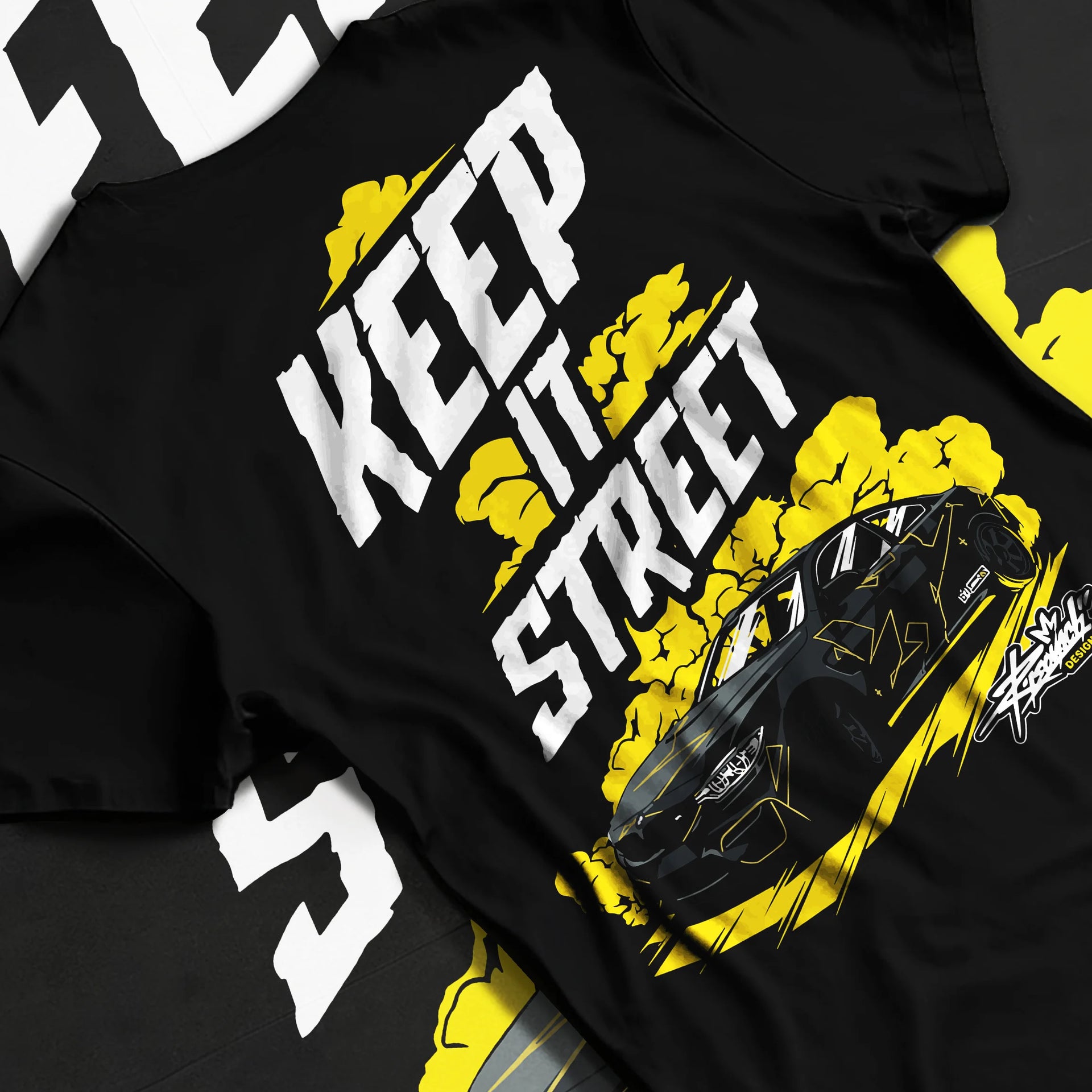 Black T-shirt laid flat with natural fabric folds, featuring turbo racing drift tuner street performance motorsport graphic.