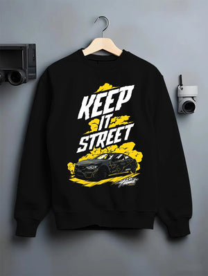 Black crewneck sweatshirt on a hanger against a grey wall, featuring turbo racing drift tuner street performance motorsport graphic.
