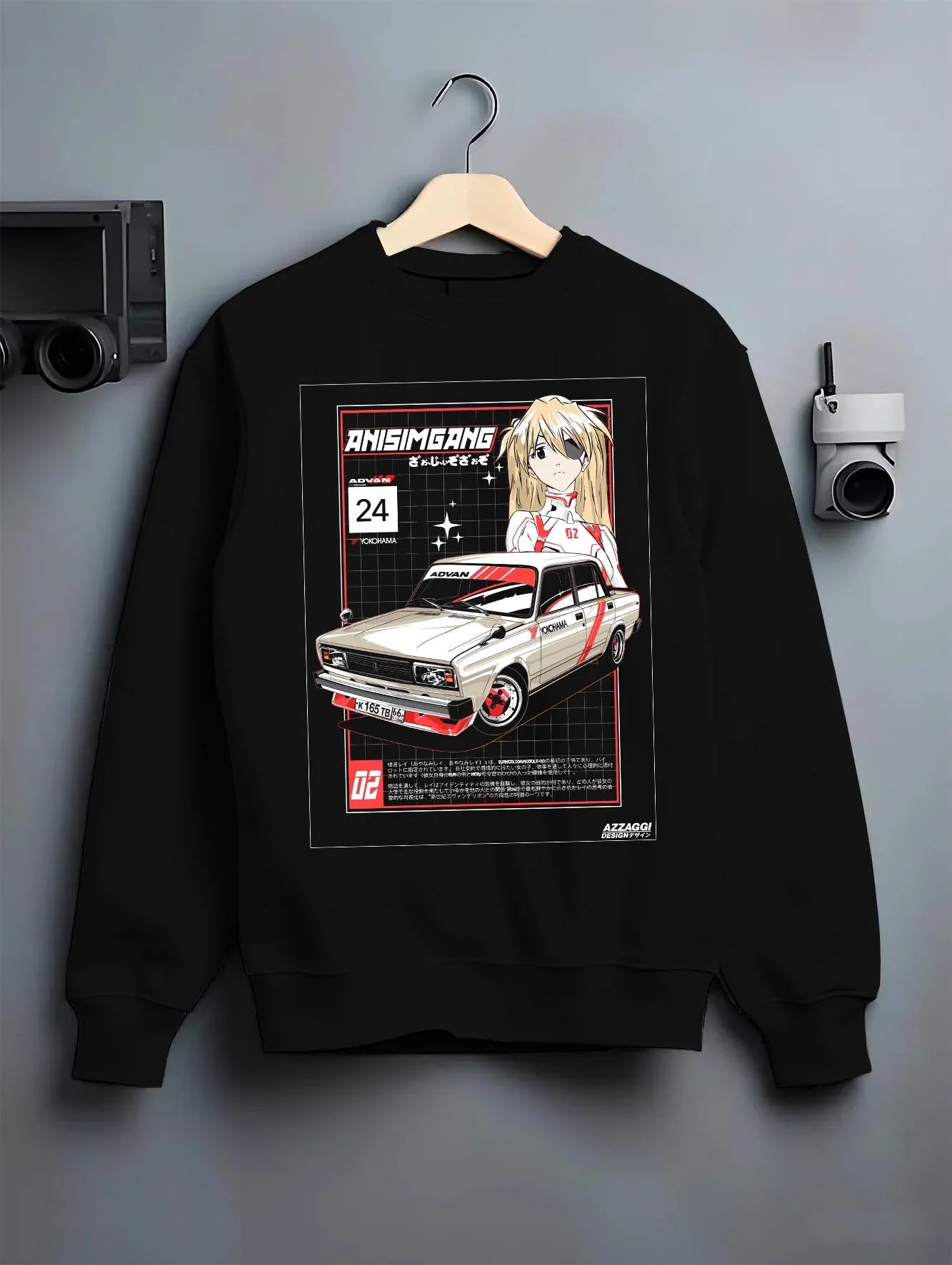 Black crewneck sweatshirt on a hanger against a grey wall, featuring drift jdm tuning retro classic racing street graphic.