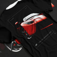 Black T-shirt laid flat with natural fabric folds, featuring Ferrari rs racing street performance motorsport automotive graphic.