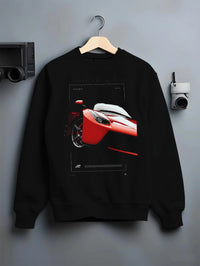 Black crewneck sweatshirt on a hanger against a grey wall, featuring Ferrari rs racing street performance motorsport graphic.