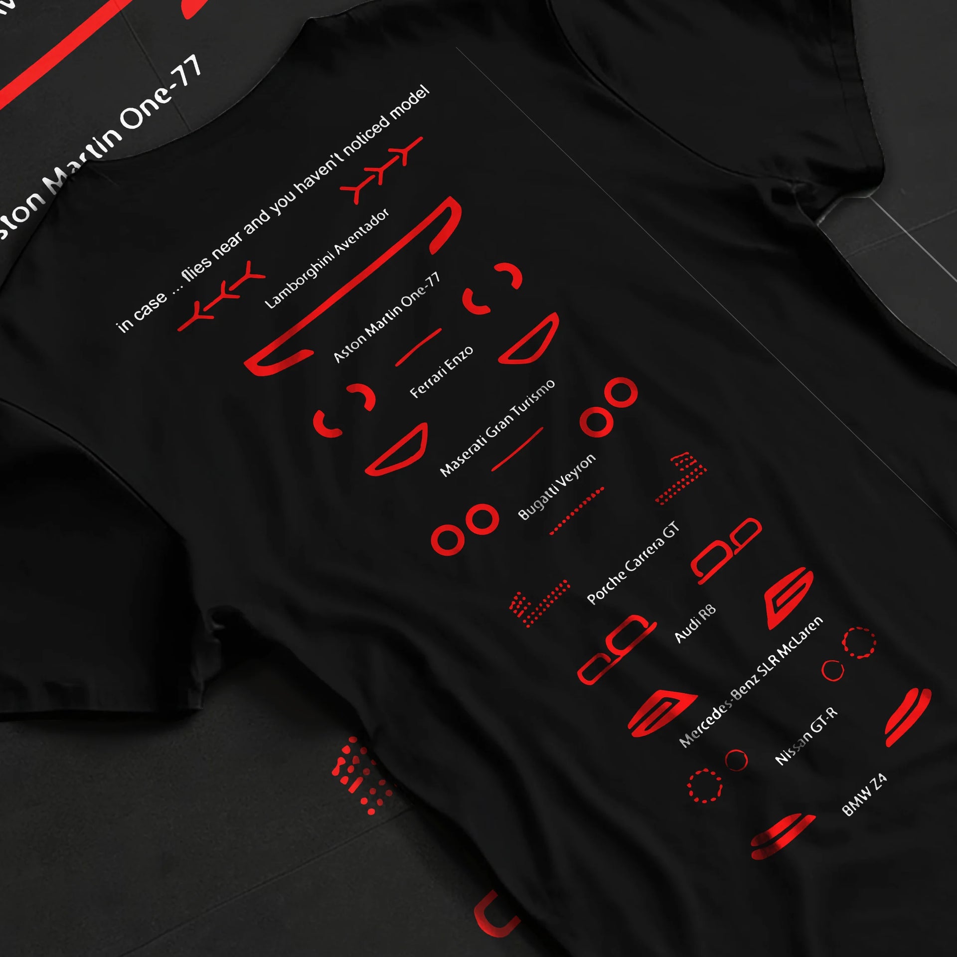 Black T-shirt laid flat with natural fabric folds, featuring Lamborghini Aventador racing italian tuning street performance graphic.