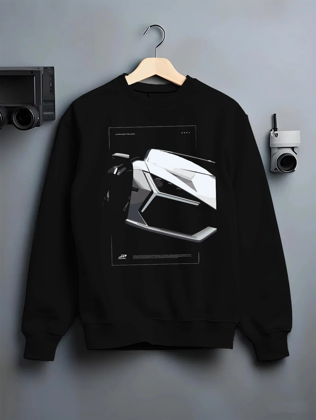 Black crewneck sweatshirt on a hanger against a grey wall, featuring SKYLINE street racing performance motorsport graphic.