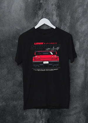 Black crewneck T-shirt on a hanger against a grey wall, featuring NISSAN SKYLINE racing jdm widebody liberty walk street graphic.