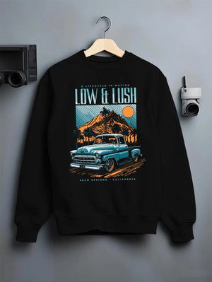 Black crewneck sweatshirt on a hanger against a grey wall, featuring Chevrolet retro classic racing street performance graphic.