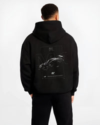 Black hoodie worn by a male model, back view, featuring BMW M4 gt3 racing race gran turismo street performance graphic.