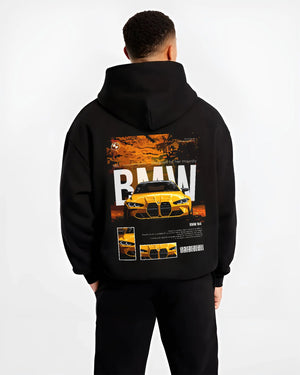 Black hoodie worn by a male model, back view, featuring BMW M4 racing drift street performance motorsport automotive graphic.