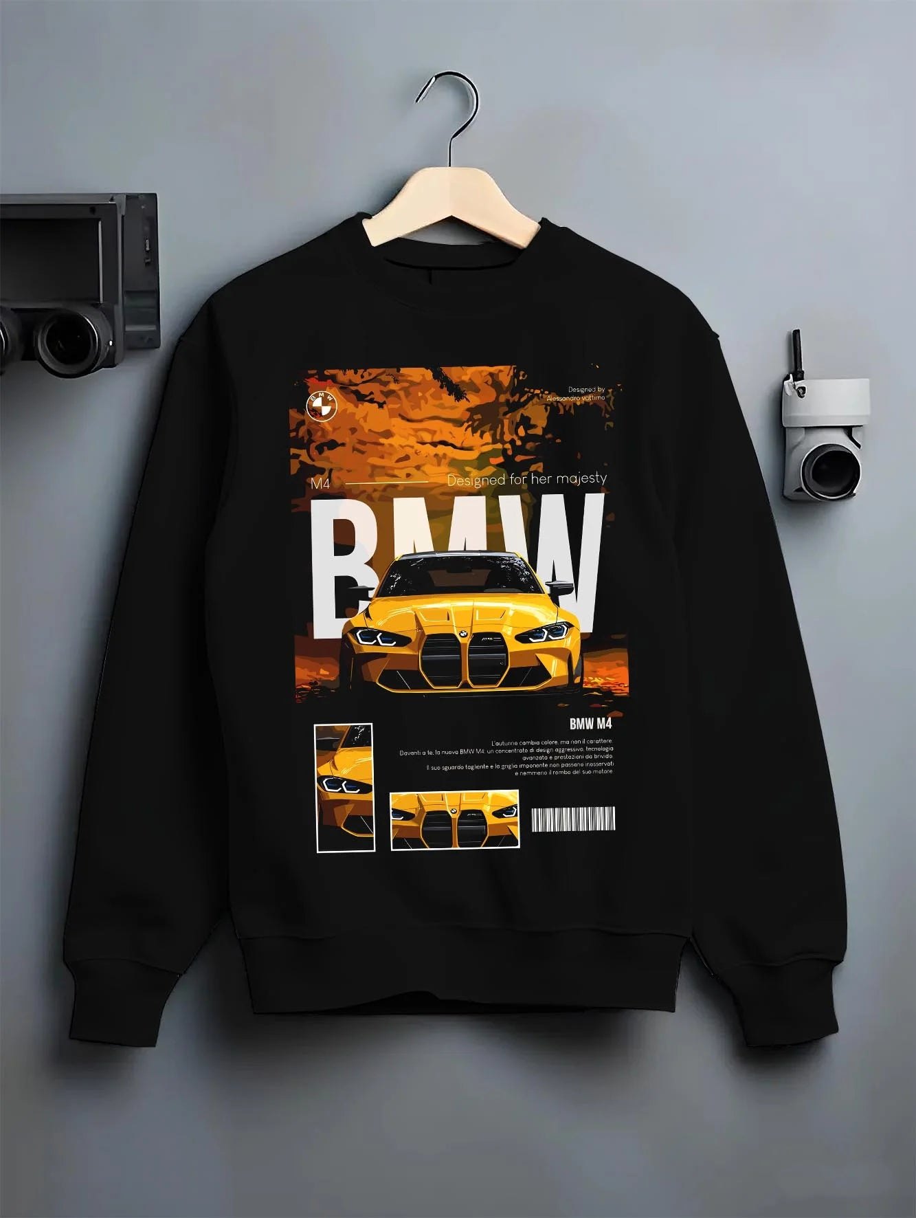Black crewneck sweatshirt on a hanger against a grey wall, featuring BMW M4 racing drift street performance motorsport graphic.