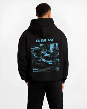 Black hoodie worn by a male model, back view, featuring BMW M5 rs turbo racing motorsport euro german street graphic.