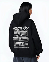 Black hoodie worn by a female model, back view, featuring Mazda RX--7 rx 7 racing drift jdm japanese street graphic.