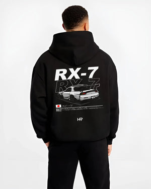 Black hoodie worn by a male model, back view, featuring Mazda RX--7 rx 7 racing drift jdm japanese street graphic mazr2.
