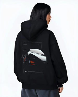 Black hoodie worn by a female model, back view, featuring McLaren F1 rs racing street retro speed enthusiast graphic.