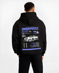 Black hoodie worn by a male model, back view, featuring NISSAN SKYLINE r34 racing race drift jdm japanese street midnight graphic.