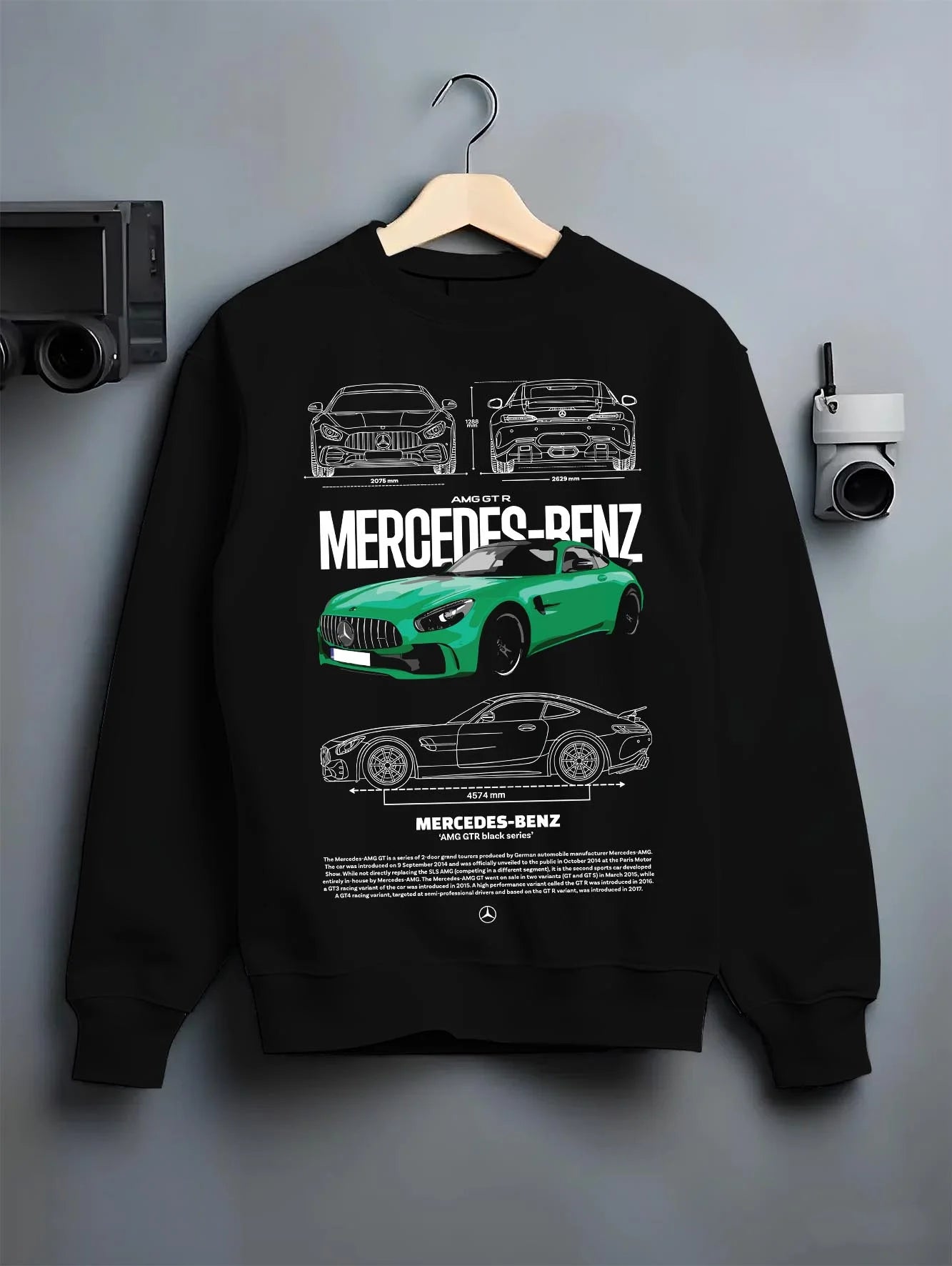 Black crewneck sweatshirt on a hanger against a grey wall, featuring Mercedes-Benz AMG rs racing motorsport street mergt6.
