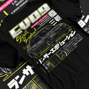 Black T-shirt laid flat with natural fabric folds, featuring street retro racing performance motorsport automotive graphic.