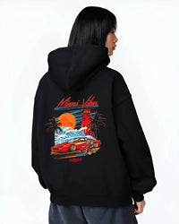 Black hoodie worn by a female model, back view, featuring street retro racing performance motorsport automotive enthusiast miamv1.