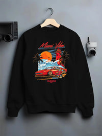Black crewneck sweatshirt on a hanger against a grey wall, featuring street retro racing performance motorsport automotive miamv1.