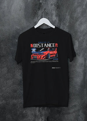 Black crewneck T-shirt on a hanger against a grey wall, featuring Mitsubishi EVO turbo racing drift jdm japanese street graphic.
