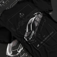 Black T-shirt laid flat with natural fabric folds, featuring Mitsubishi Lancer evo turbo racing drift jdm japanese street graphic.