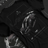 Black T-shirt laid flat with natural fabric folds, featuring Mitsubishi EVO turbo turbocharged racing drift jdm japanese graphic.