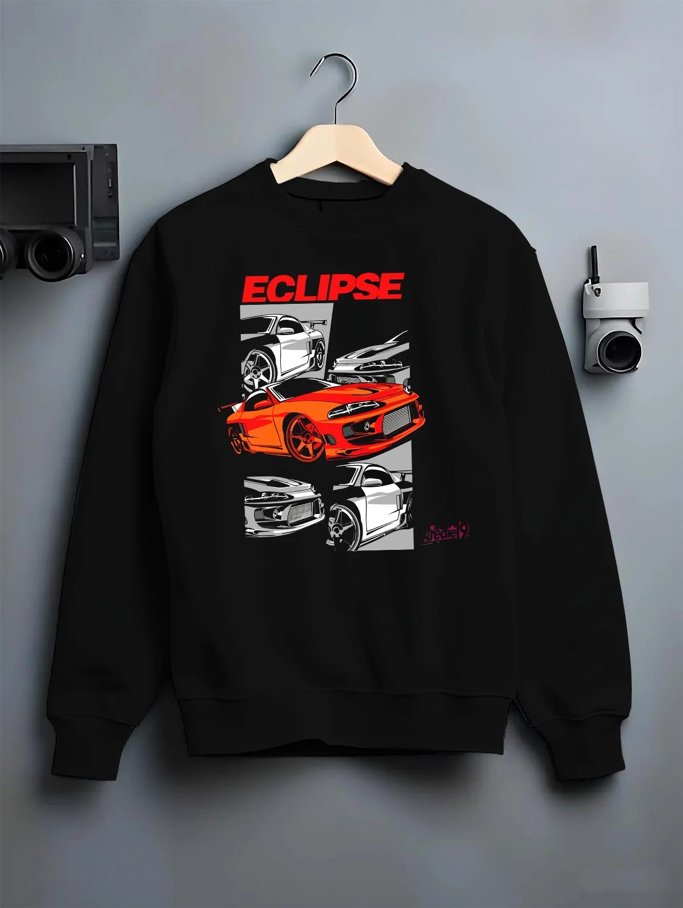 Black crewneck sweatshirt on a hanger against a grey wall, featuring Mitsubishi Lancer turbo racing drift track jdm street graphic.