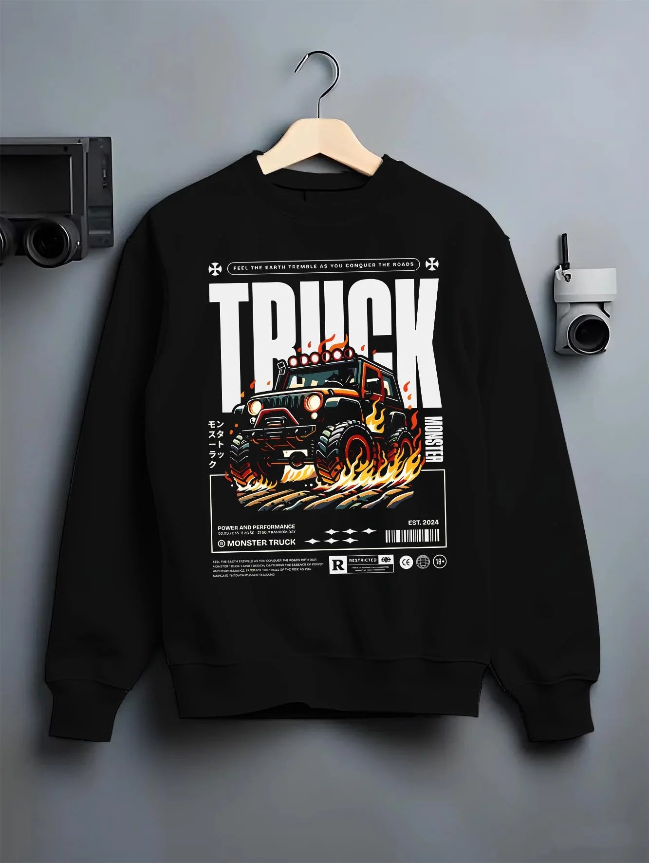 Black crewneck sweatshirt on a hanger against a grey wall, featuring rs racing drift motorsport jdm tuner street monster graphic.