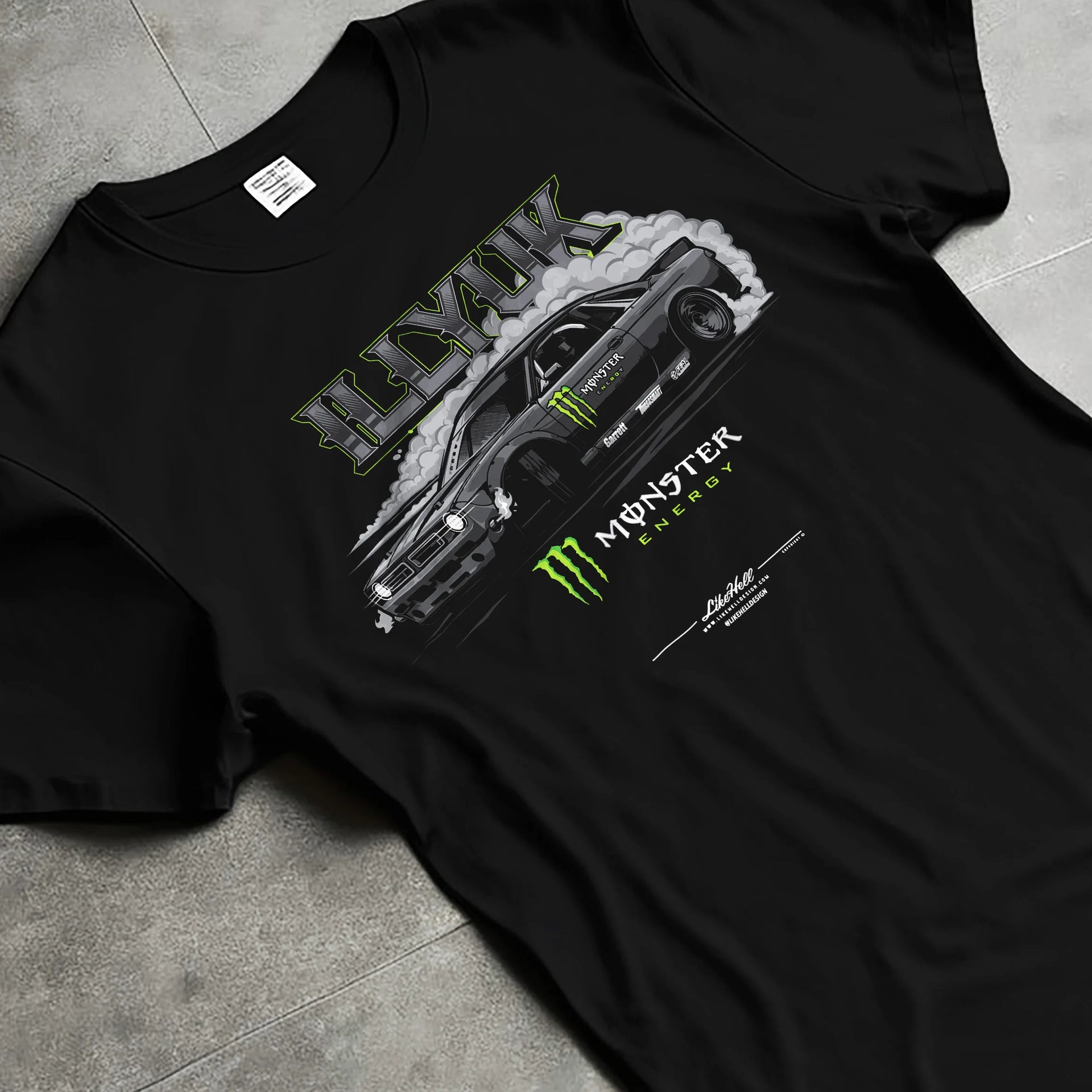 Black T-shirt laid flat with natural fabric folds, featuring rs turbo racing drift motorsport tuner street monster graphic.