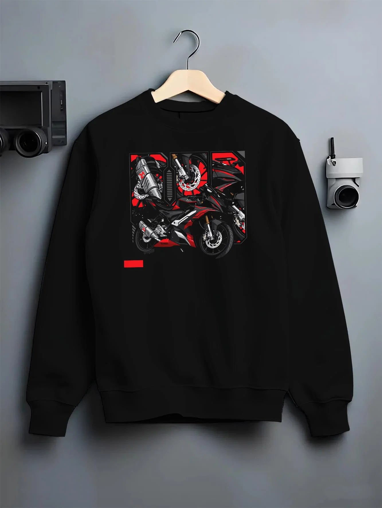 Black crewneck sweatshirt on a hanger against a grey wall, featuring rs speed enthusiast racing street performance graphic.