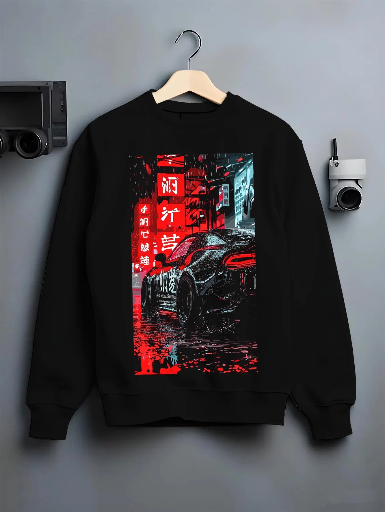 Black crewneck sweatshirt on a hanger against a grey wall, featuring racing drift jdm japanese street enthusiast graphic.