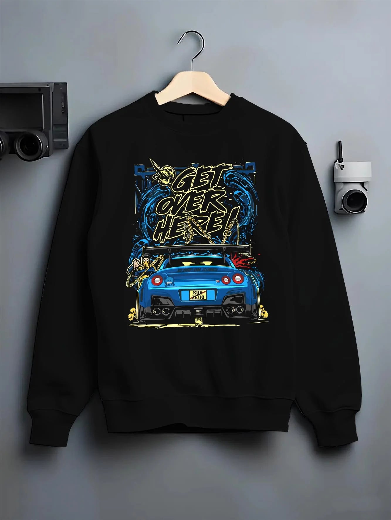 Black crewneck sweatshirt on a hanger against a grey wall, featuring Nissan 350Z turbo turbocharged racing drift jdm graphic.