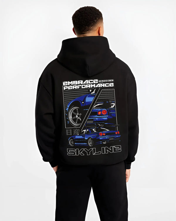 Black hoodie worn by a male model, back view, featuring Nissan Skyline R34 r34 skyline turbo jdm legend racing graphic.