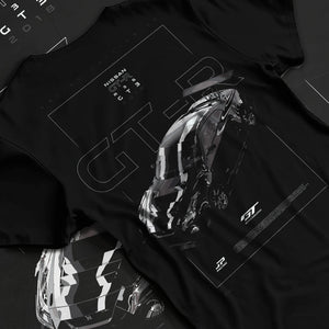 Black T-shirt laid flat with natural fabric folds, featuring Nissan FAIRLADY turbo turbocharged drift jdm japanese tuner graphic.