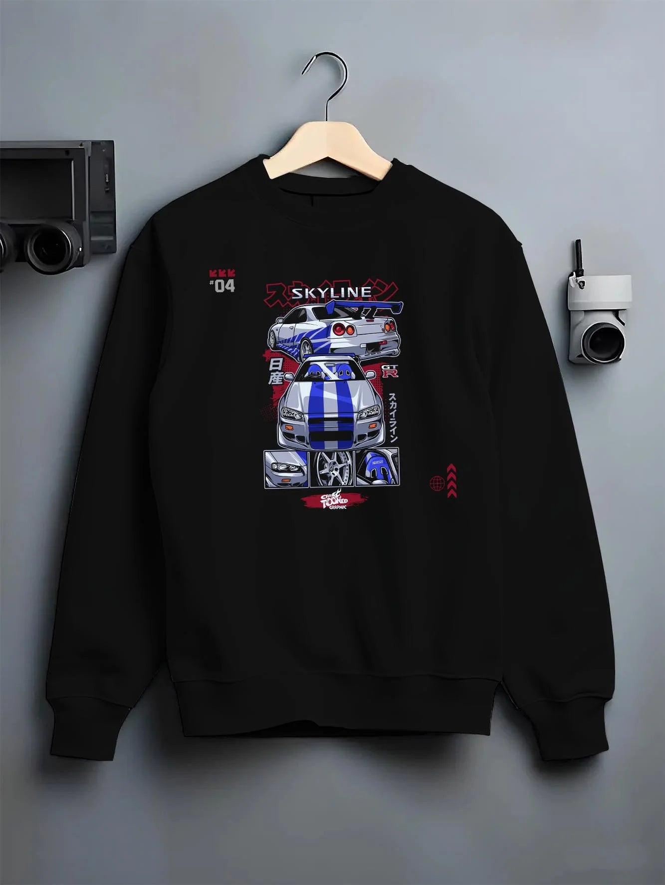 Black crewneck sweatshirt on a hanger against a grey wall, featuring Nissan Skyline R34 gt r r34 skyline drift jdm racing graphic.